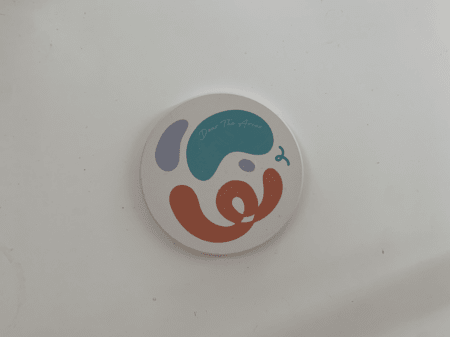 <b>Coaster Front</b><br> I used my phone to photograph the front of the coaster, showcasing the printed design and the contrast with the white background. I chose this object because it is a simple flat cylinder with a design that creates a contrasting effect.