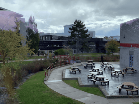 <b>Outdoor Picnic Area with Benches</b><br>I took this photo on Sheridan campus, capturing an outdoor picnic area with benches. Originally created for students and staff to dine or study outdoors, it continues to serve the same purpose, providing a space for gathering, studying, or relaxing, especially on pleasant days.