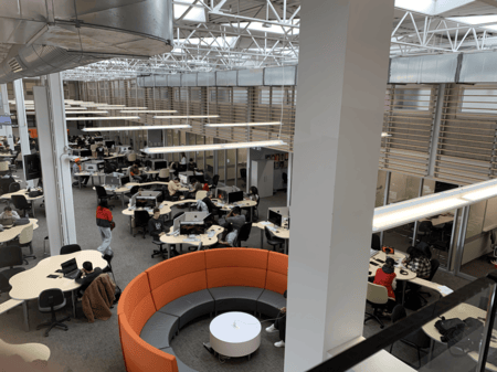 <b>Collaborative Study Area with Circular Seating</b><br>I took this photo on Sheridan campus with my phone, capturing the collaborative study area. Originally designed for group work and discussion, this space with its circular seating continues to be used by students for both individual study and teamwork. The open layout and modern design encourage collaboration and focus.