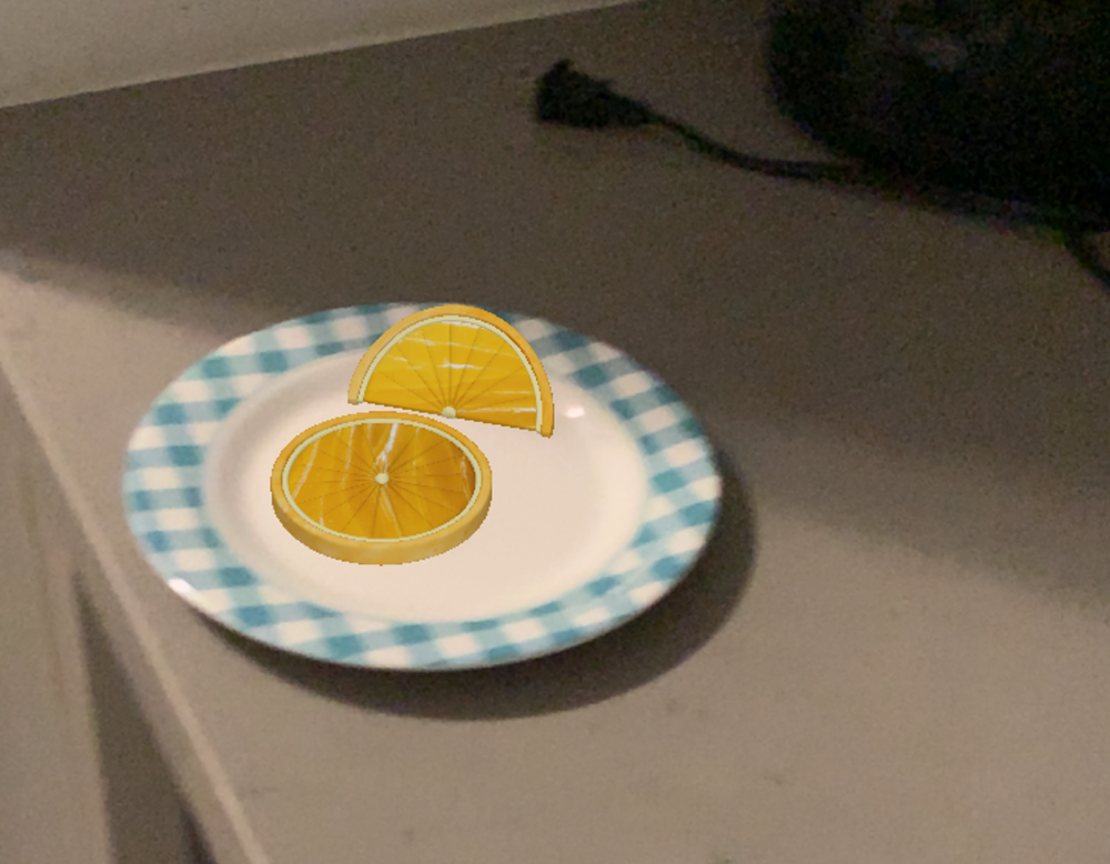 <b>Orange Slices on the Plate</b><br>
          Here, I imported my orange slice model into AR and placed it on a plate in the kitchen. It looks natural on the plate, just like real fruit ready to be served.