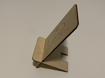 <b>Side View of the Phone Stand</b><br>
          Here, you can see the phone stand from the side. The angled design allows the phone to rest comfortably, with the ghost image still visible from this perspective. The laser cut edges are smooth and precise.