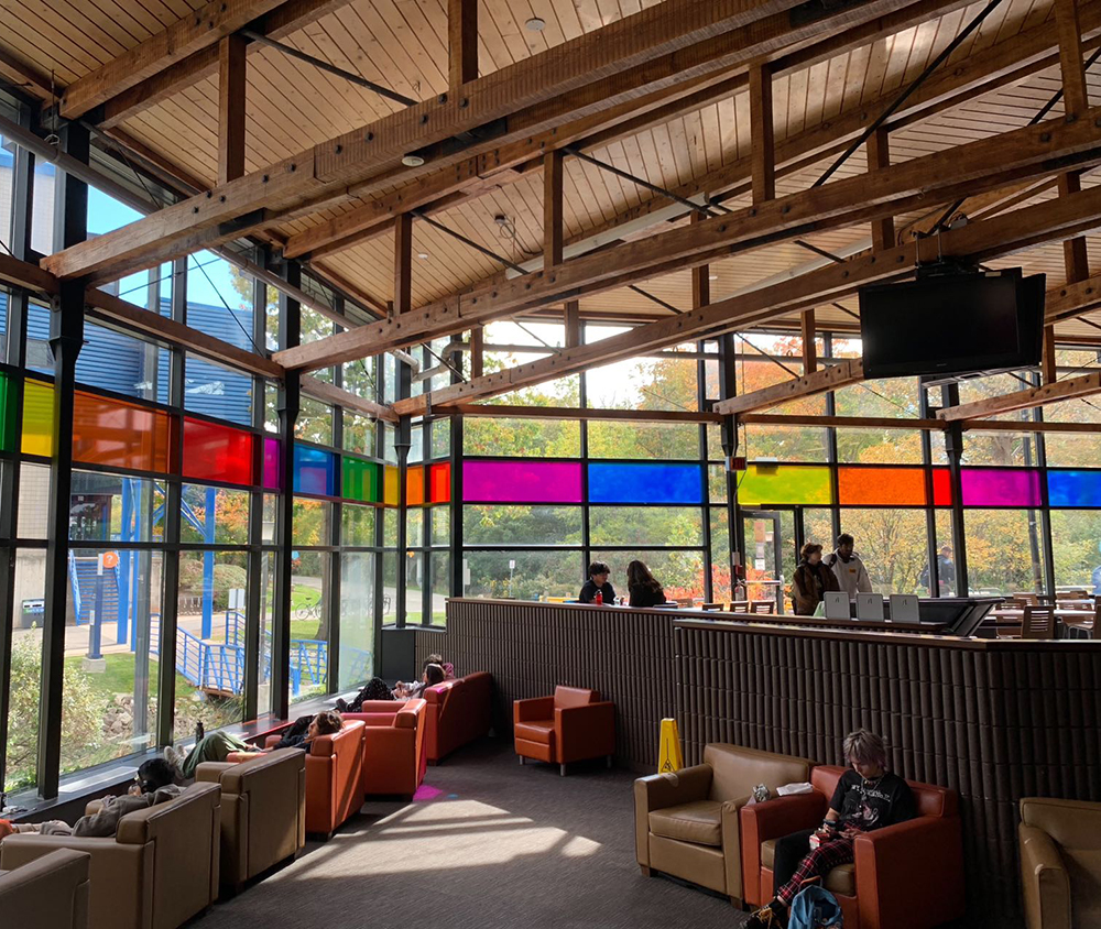 <ul>
          <b>Dining area</b><br>
          This space is a dining area at Sheridan College, located in A wing. It’s an indoor, permanent space made interesting by the colorful glass panels that bring in vibrant light. Students mainly use this area to relax, eat, and study in a cozy and welcoming atmosphere.

          </ul>