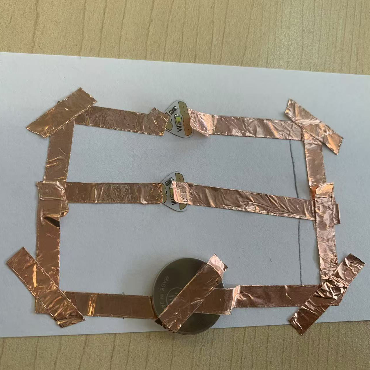 I constructed the parallel circuit using copper tape and LEDs. The setup aligns with the drawn diagram.