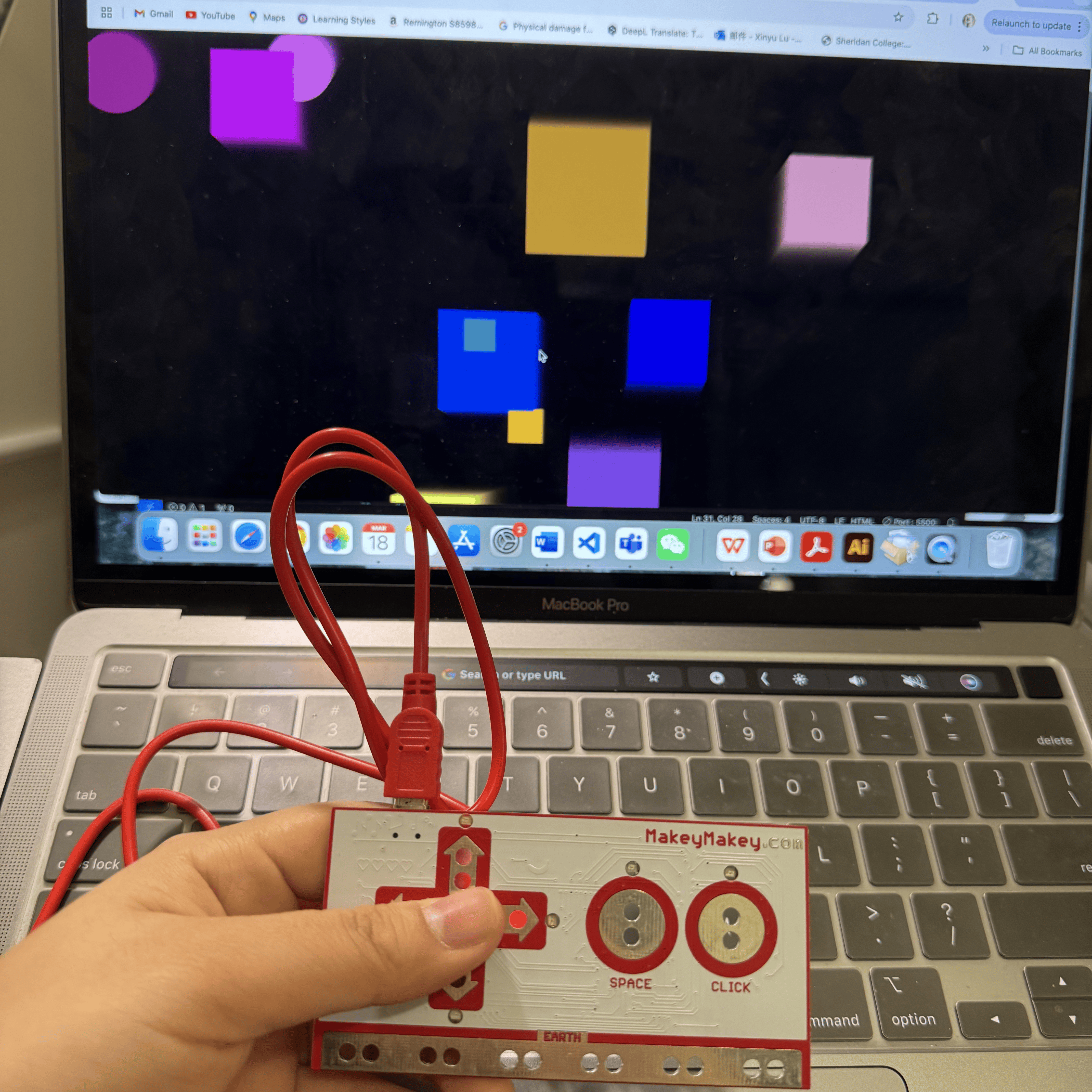 In this photo, I'm using a Makey Makey device to interact with a colorful visual application displayed on my laptop screen. By pressing the arrow keys on the Makey Makey, I can manipulate the shapes appearing on the screen, making the interaction playful and visually engaging.