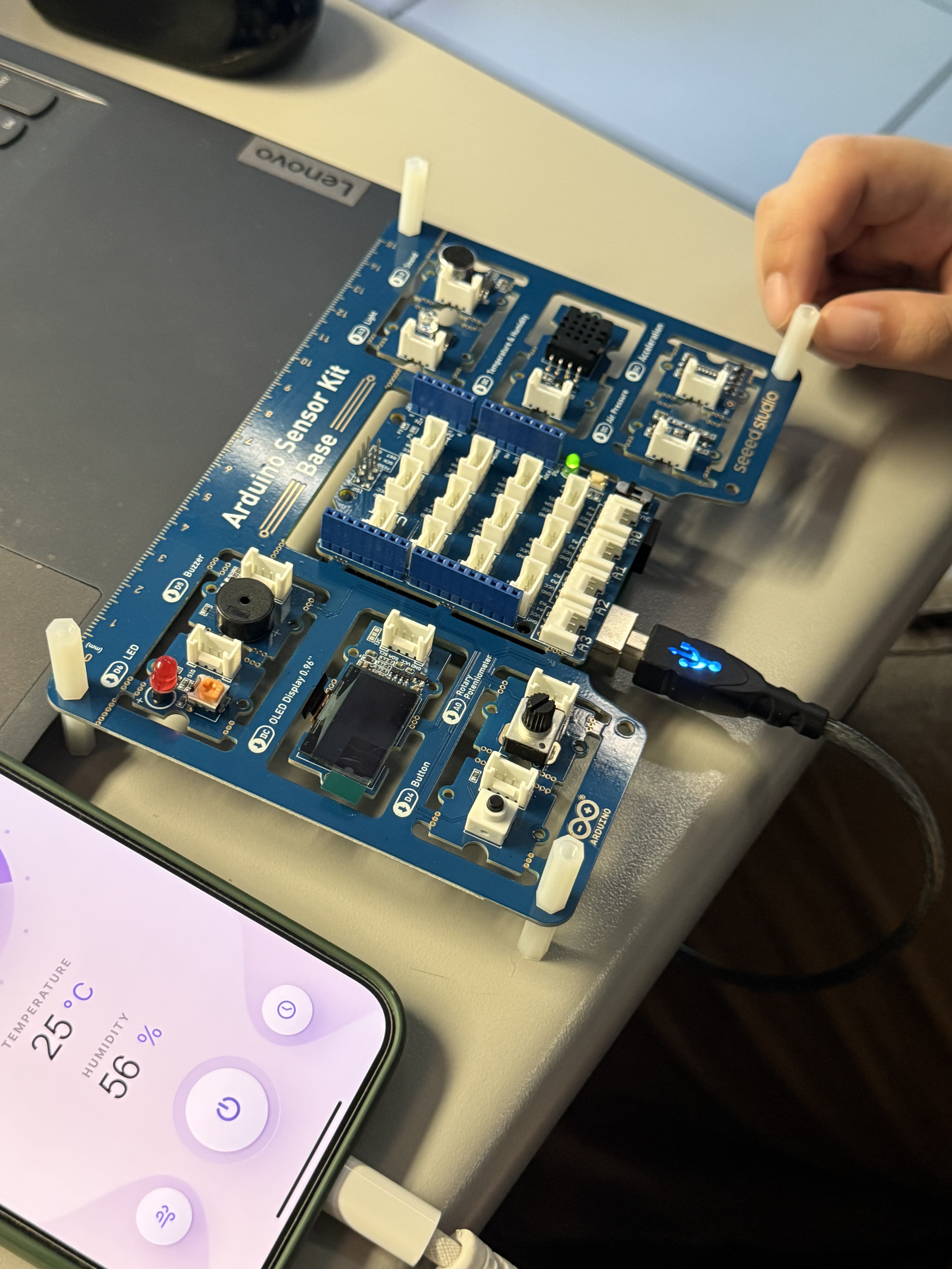 <b>Using the Arduino Sensor Kit</b><br>I connected my Arduino Sensor Kit to the laptop and linked it to a temperature and humidity sensor. The green light showed that the board was powered and active. I also displayed the data on my phone to compare the readings.