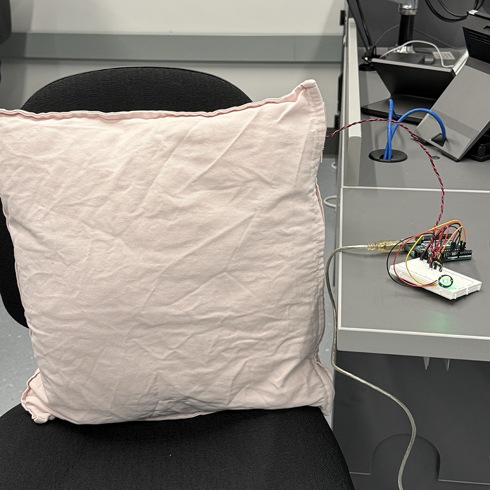 <b>Full Prototype Connection Test</b><br>We connected the cushion and sensors to the Arduino to test the full prototype. This setup allowed us to read both the force and pulse data in real time, which will later be sent to TouchDesigner to create the responsive visuals.
